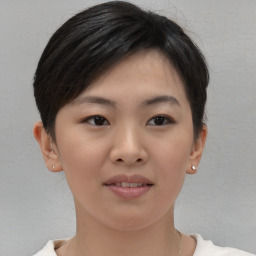 Joyful asian young-adult female with short  brown hair and brown eyes