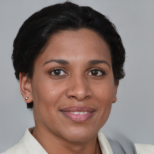 Joyful latino young-adult female with short  brown hair and brown eyes