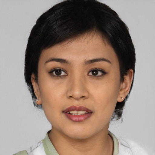 Joyful latino young-adult female with medium  black hair and brown eyes