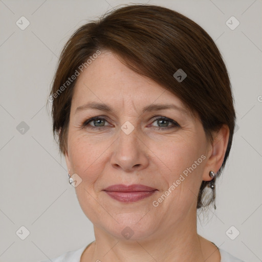 Joyful white adult female with medium  brown hair and grey eyes