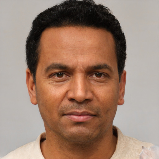 Neutral latino adult male with short  black hair and brown eyes