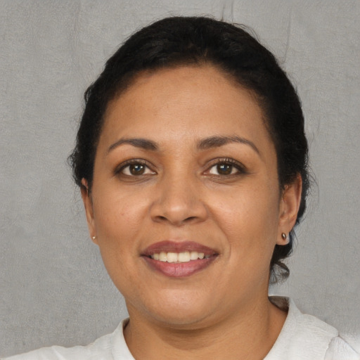 Joyful white adult female with short  black hair and brown eyes