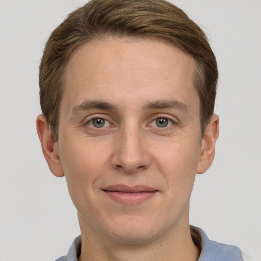 Joyful white adult male with short  brown hair and grey eyes