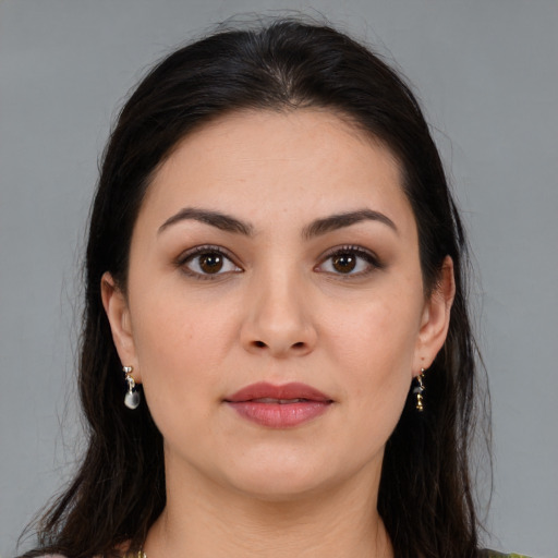 Joyful white young-adult female with long  brown hair and brown eyes