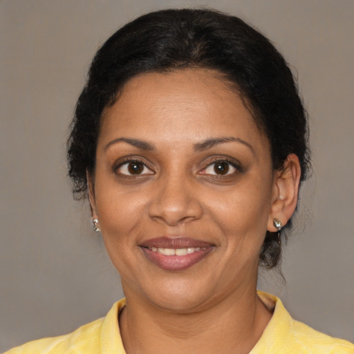 Joyful black adult female with short  brown hair and brown eyes