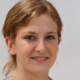 Joyful white young-adult female with medium  brown hair and blue eyes