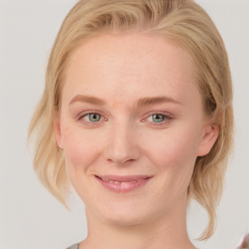 Joyful white young-adult female with medium  blond hair and blue eyes