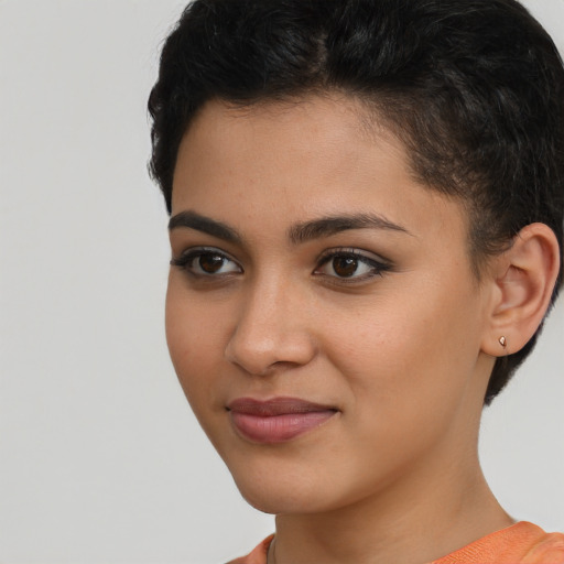 Joyful latino young-adult female with short  brown hair and brown eyes