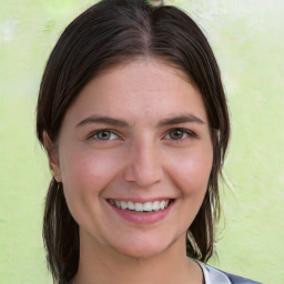 Joyful white young-adult female with medium  brown hair and green eyes