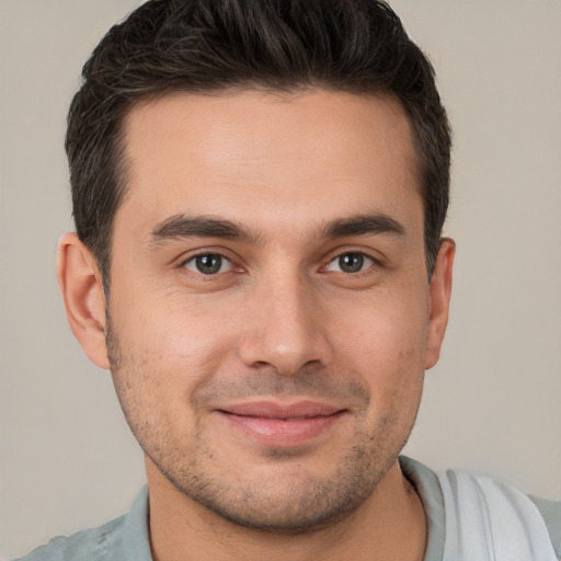 Joyful white young-adult male with short  brown hair and brown eyes