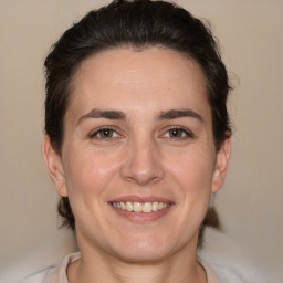 Joyful white adult female with medium  brown hair and brown eyes