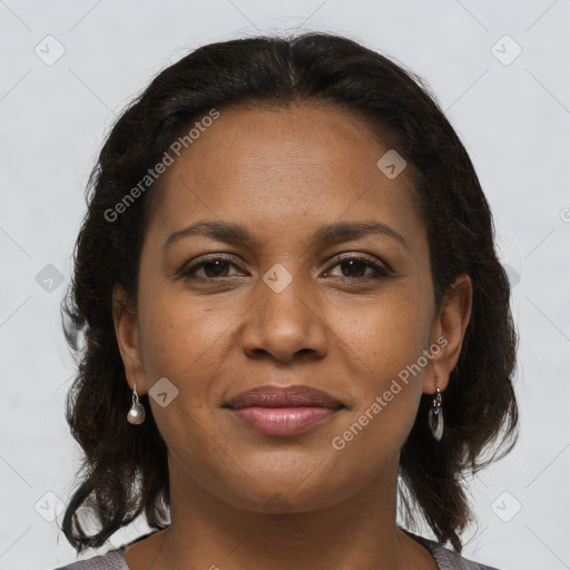 Joyful black young-adult female with long  brown hair and brown eyes