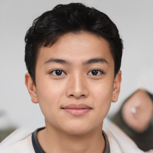 Joyful asian young-adult male with short  brown hair and brown eyes