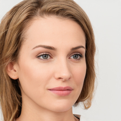 Joyful white young-adult female with long  brown hair and green eyes