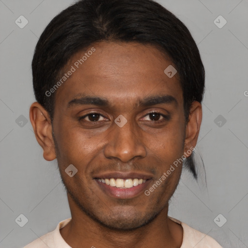 Joyful black young-adult male with short  brown hair and brown eyes