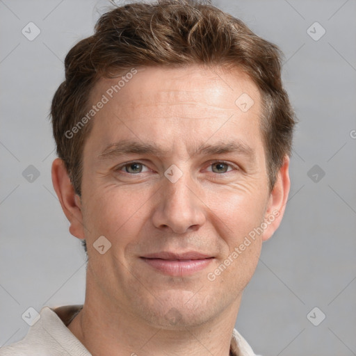 Joyful white adult male with short  brown hair and grey eyes