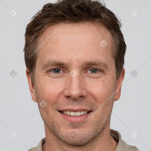 Joyful white adult male with short  brown hair and grey eyes