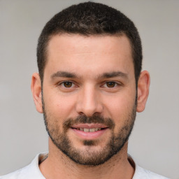 Joyful white young-adult male with short  brown hair and brown eyes