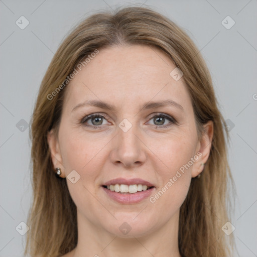 Joyful white adult female with long  brown hair and grey eyes