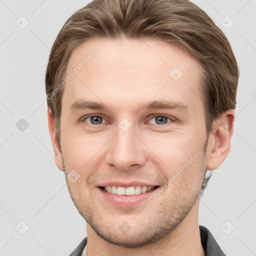 Joyful white young-adult male with short  brown hair and grey eyes