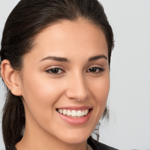 Joyful white young-adult female with medium  brown hair and brown eyes