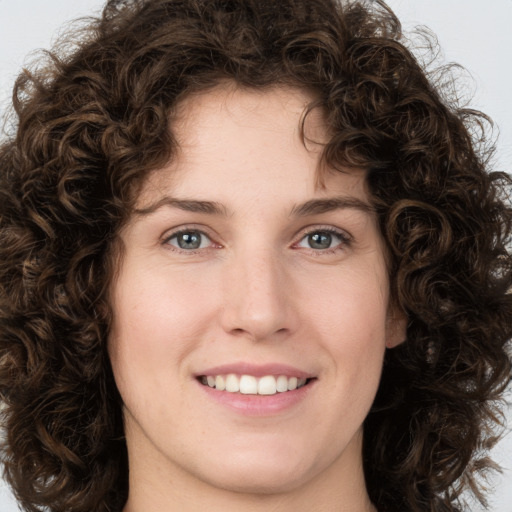 Joyful white young-adult female with medium  brown hair and green eyes