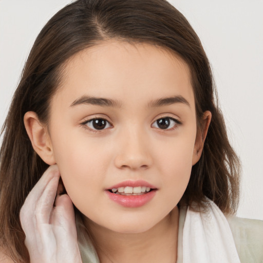 Joyful white child female with long  brown hair and brown eyes