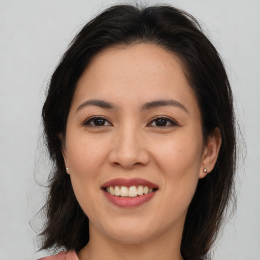 Joyful asian young-adult female with medium  brown hair and brown eyes