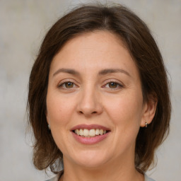 Joyful white young-adult female with medium  brown hair and green eyes