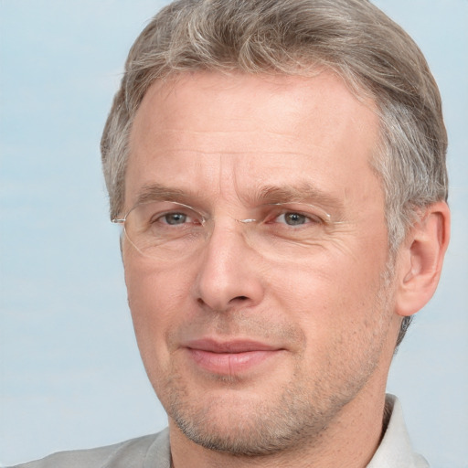 Joyful white adult male with short  brown hair and grey eyes