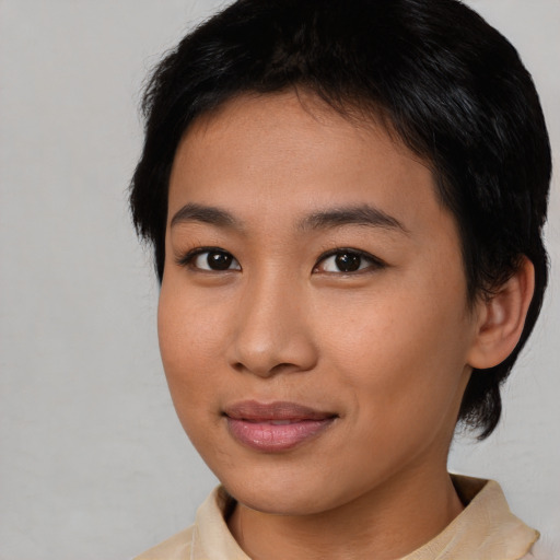 Joyful asian young-adult female with medium  brown hair and brown eyes