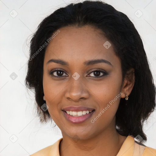 Joyful black young-adult female with long  black hair and brown eyes