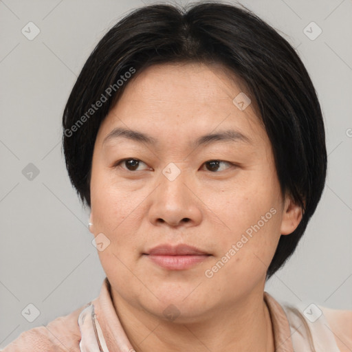 Joyful asian young-adult female with short  brown hair and brown eyes