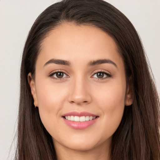 Joyful white young-adult female with long  brown hair and brown eyes