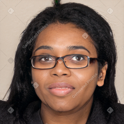 Joyful black young-adult female with long  black hair and brown eyes