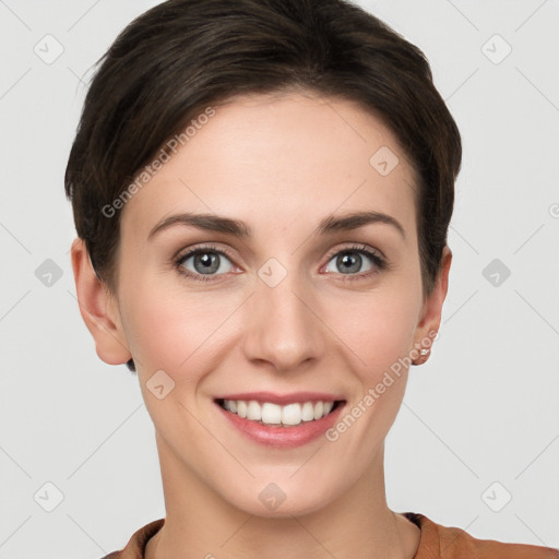 Joyful white young-adult female with short  brown hair and grey eyes