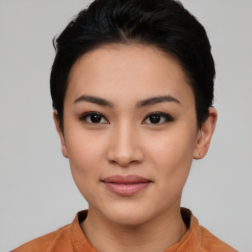 Joyful asian young-adult female with short  black hair and brown eyes
