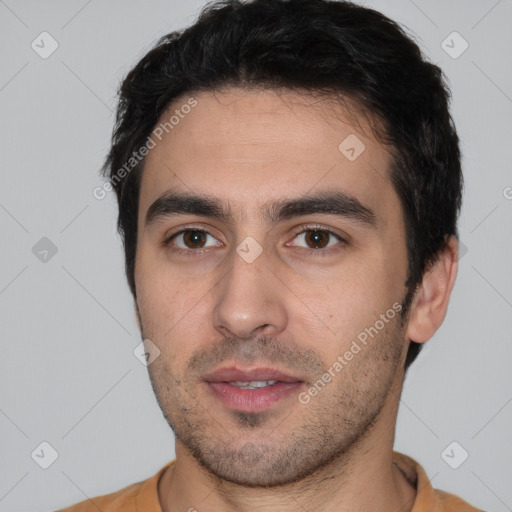Neutral white young-adult male with short  black hair and brown eyes