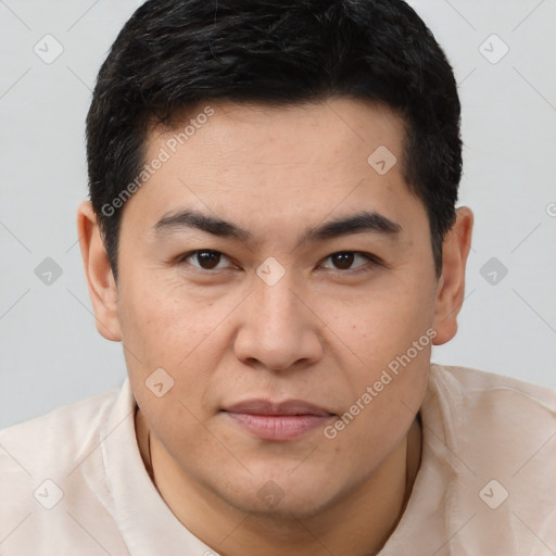 Joyful latino young-adult male with short  brown hair and brown eyes