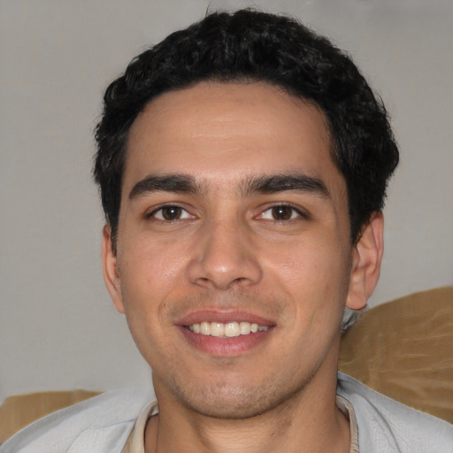 Joyful white young-adult male with short  black hair and brown eyes