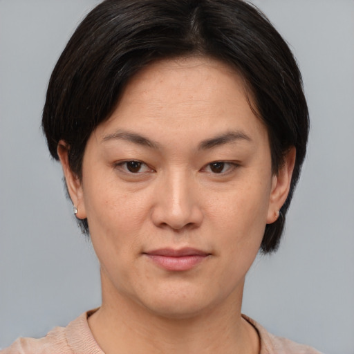 Joyful asian adult female with short  brown hair and brown eyes