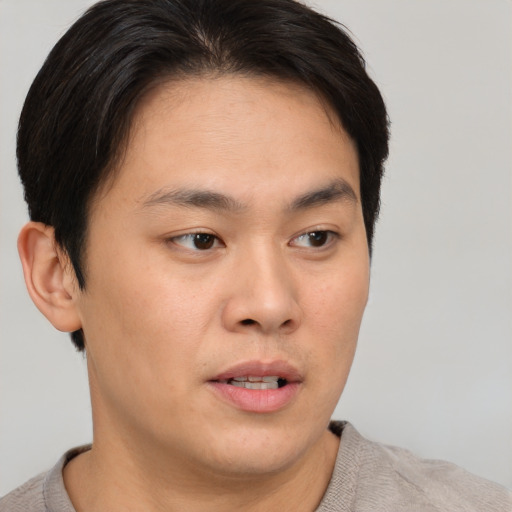 Neutral asian young-adult male with short  brown hair and brown eyes
