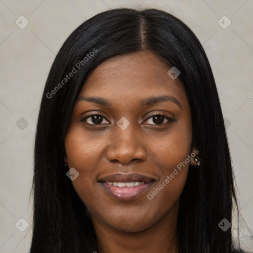 Joyful black young-adult female with long  black hair and brown eyes