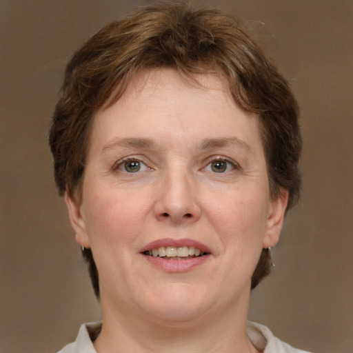 Joyful white adult female with short  brown hair and grey eyes