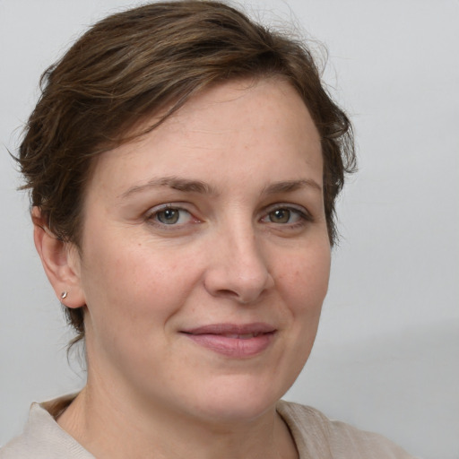 Joyful white adult female with medium  brown hair and grey eyes