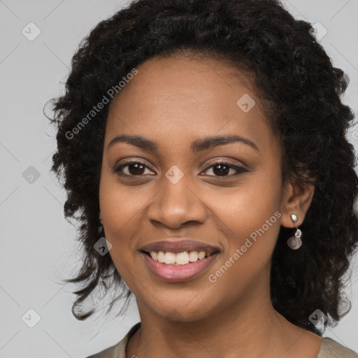 Joyful black young-adult female with long  black hair and brown eyes