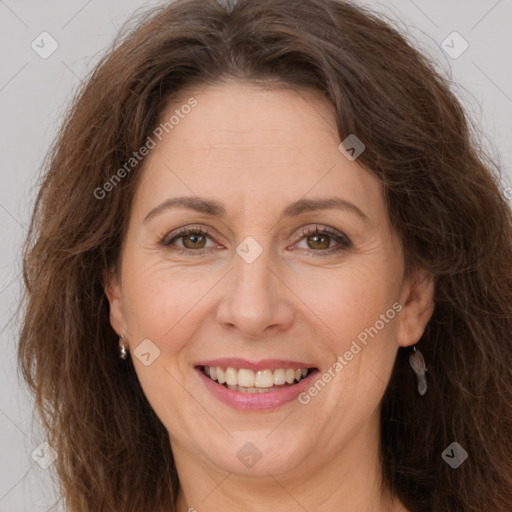 Joyful white adult female with long  brown hair and brown eyes