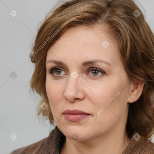 Joyful white adult female with medium  brown hair and blue eyes