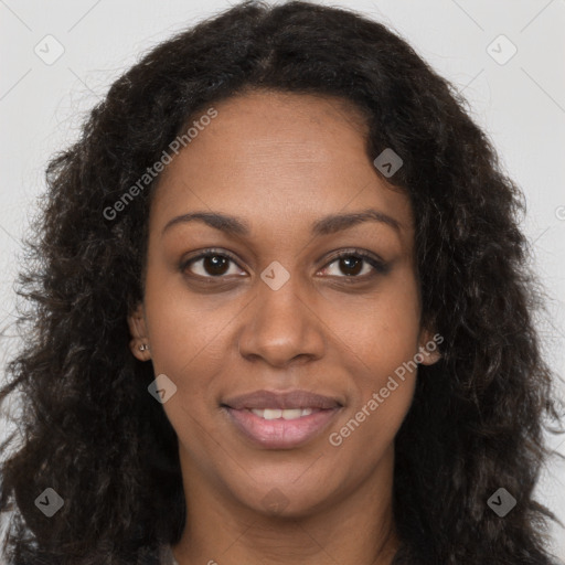 Joyful black young-adult female with long  brown hair and brown eyes