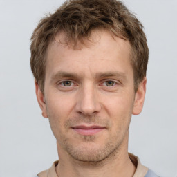 Joyful white adult male with short  brown hair and grey eyes